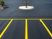 After: Freshly sealcoated parking lot